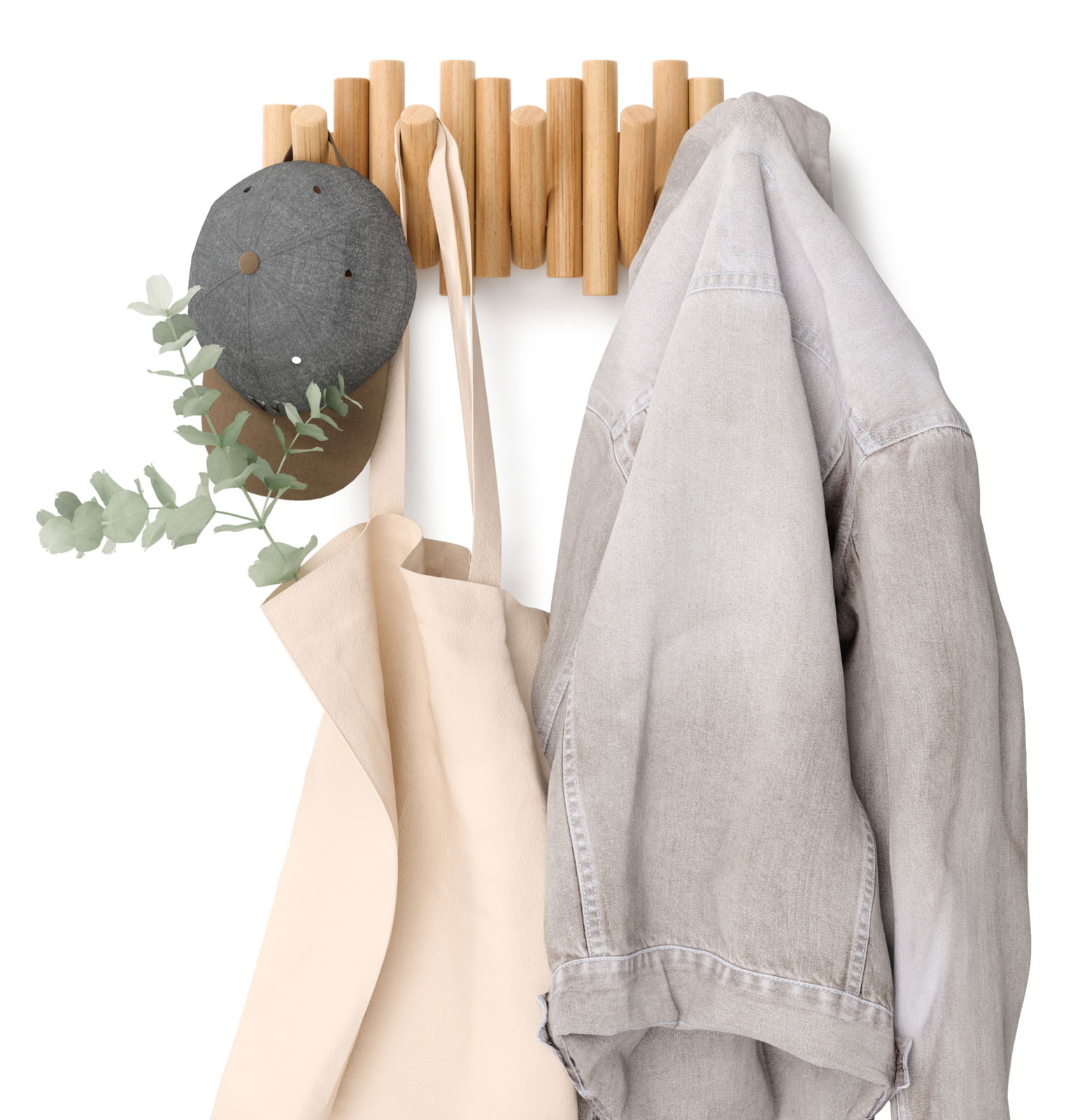 Wandgarderobe aus Holz mit Haken, an denen eine graue Mütze, eine beige Tasche und eine graue Jacke hängen. Frontalansicht.