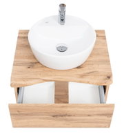 Houten wastafelmeubel met ronde witte wasbak en open lade, gezien van bovenaf