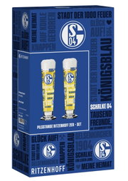 Blau gestaltete Ritzenhoff-Verpackung eines FC-Schalke-04-Pilstangen-Sets mit zwei gelb-blau bedruckten Gläsern, aus schräger Vorderansicht mit sichtbarer linker Seite.