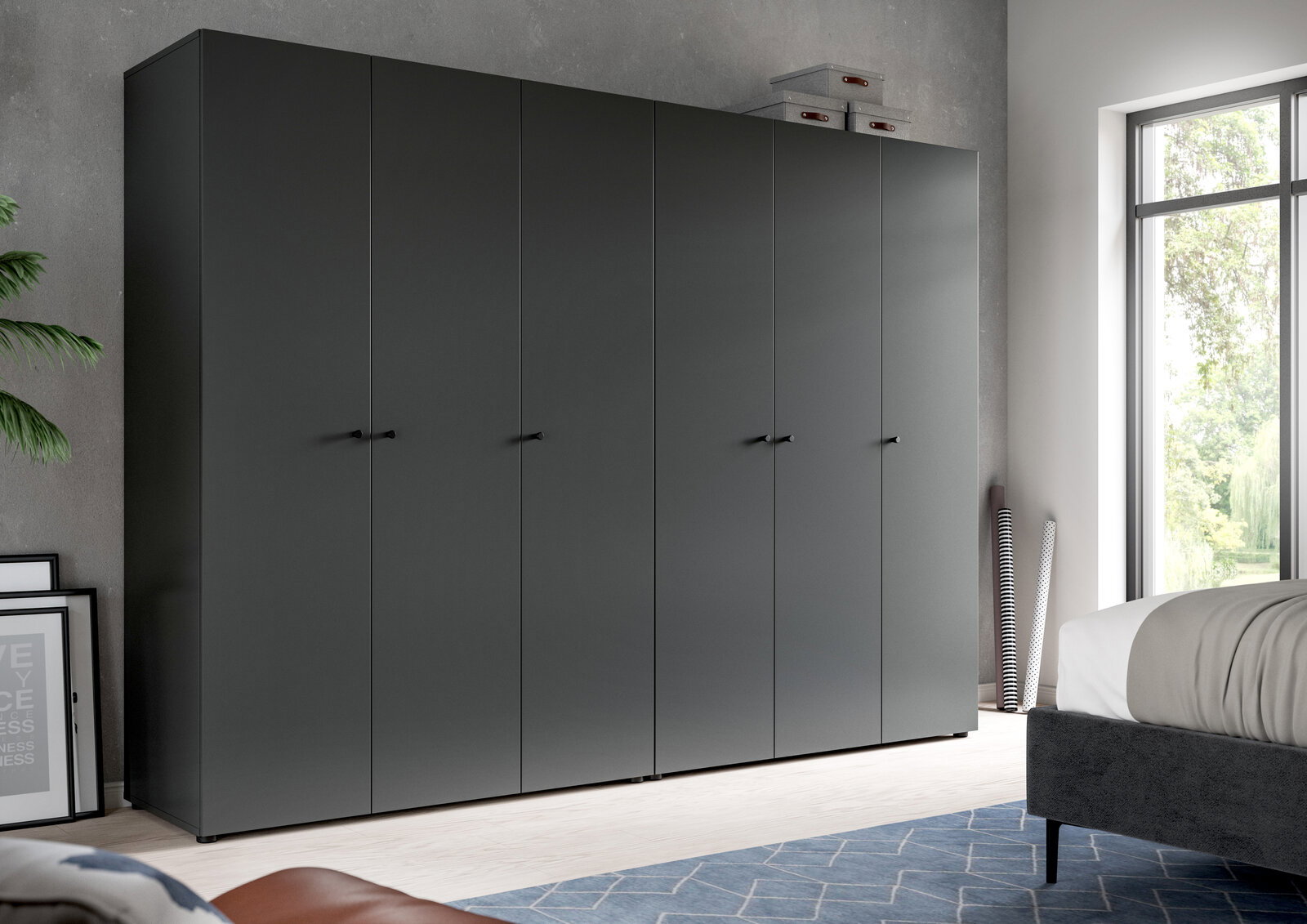 Großer, moderner Kleiderschrank in mattem Anthrazit mit mehreren Türen und schwarzen Griffen im Schlafzimmer, Frontansicht leicht schräg von links.