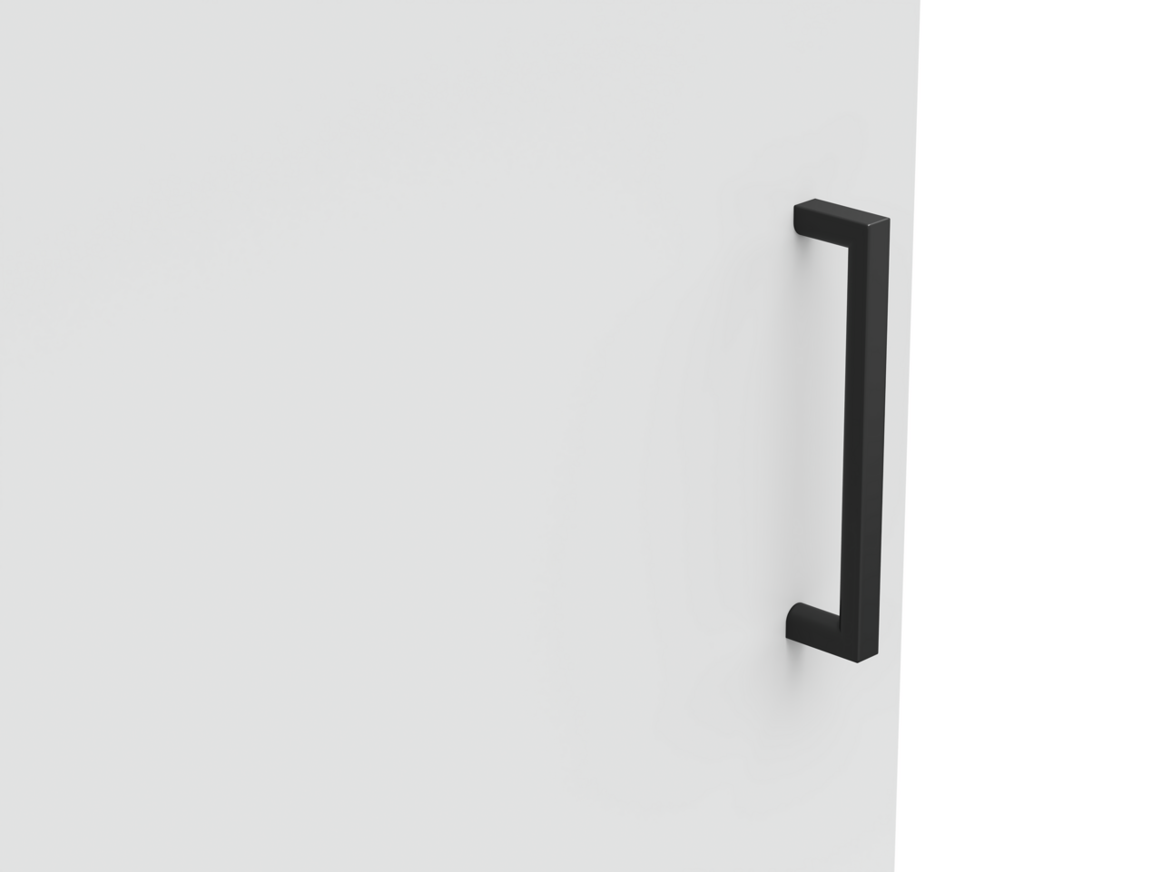 Nahaufnahme eines schwarzen Griffs an einer weißen Kommodentür, seitliche Perspektive