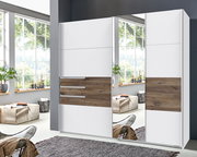 Moderner Schwebetürenschrank mit zwei Türen, einer davon mit Spiegel, in einem hellen Raum mit großen Fenstern, aus der Frontalperspektive betrachtet.