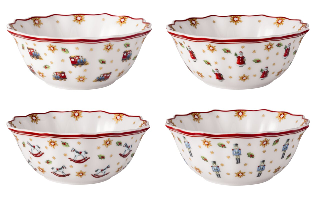 Villeroy & Boch Jubiläums Schalen-Set 4tlg Vier weiße Schalen mit weihnachtlichen Motiven wie Spielzeugzug, Weihnachtsmann, Schaukelpferd und Nussknacker, aus einer leicht erhöhten Perspektive fotografiert.