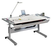 Moderner Schreibtisch mit höhenverstellbaren Beinen, ausgestattet mit einer Schreibtischlampe, Tablet-Halterung und mehreren Ablagefächern, seitliche Perspektive.