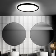 Moderne LED-Deckenleuchte mit Bewegungssensor, von unten betrachtet, in einem stilvollen Badezimmer mit runden Spiegeln und weißen Fliesen.