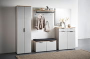 Moderne Garderobenkombination in hellem Raum, bestehend aus einem hohen Schrank, einem Garderobenpaneel mit Haken und Ablage, einer Schuhbank mit Sitzkissen und einem Schuhschrank mit Spiegel. Frontalansicht.
