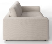 Zijaanzicht van een beige tweezitsbank met een strak ontwerp en rechte lijnen.