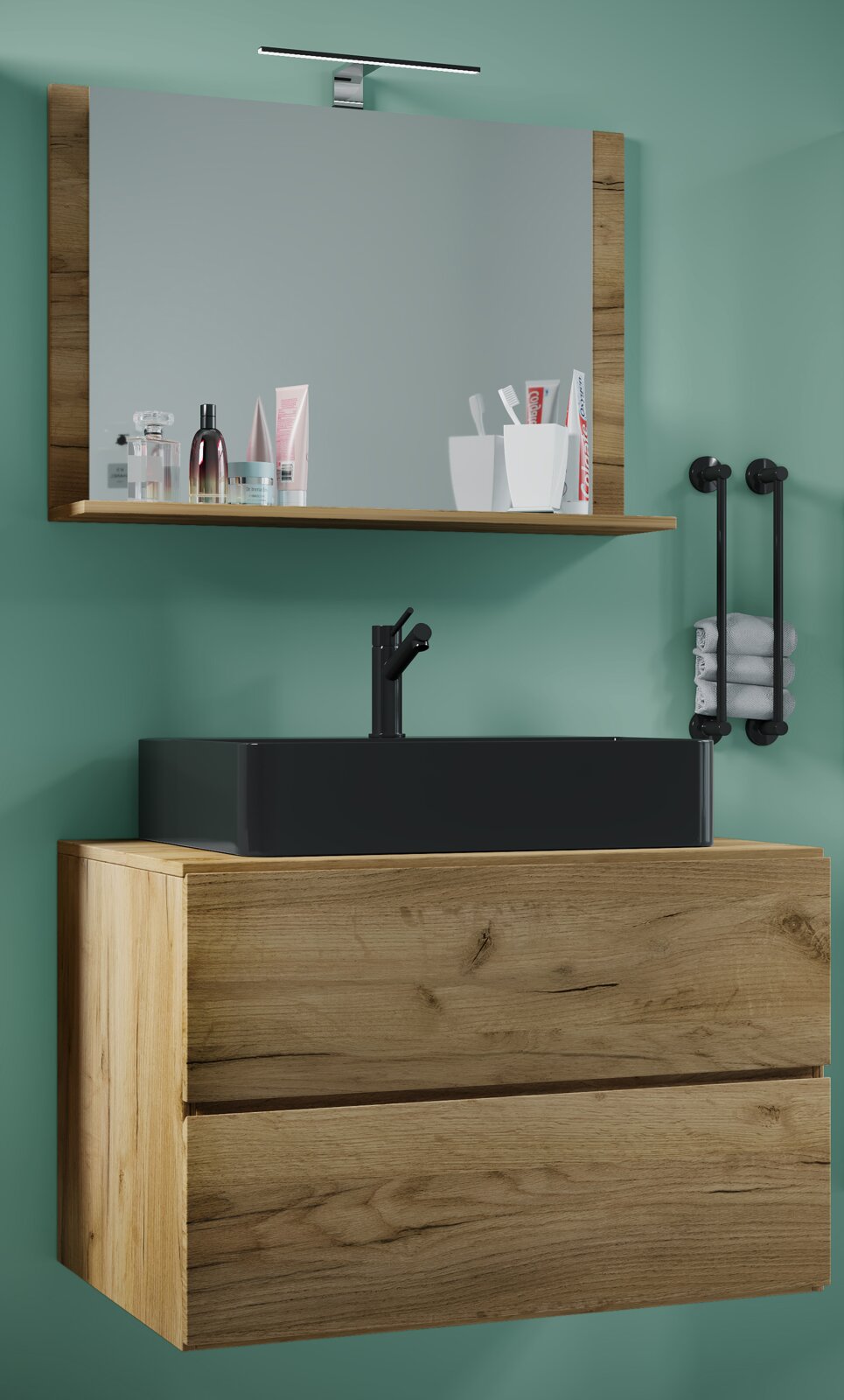 Frontale Ansicht eines modernen Badezimmer-Waschtischs in Holzoptik mit schwarzem Aufsatzwaschbecken und Armatur, darüber Spiegel mit Holzrahmen, Ablage und LED-Spiegelleuchte an grüner Wand