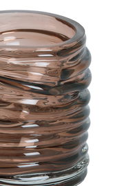 Nahaufnahme eines gerippten, braunen Glas-Teelichthalters mit glänzender Oberfläche.