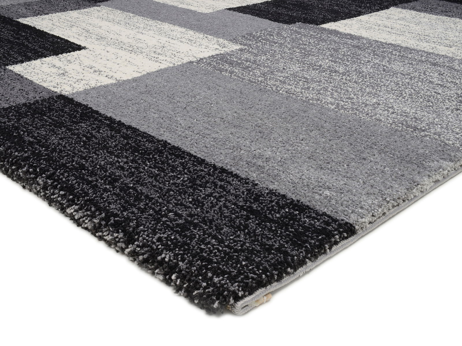 Frisé-Teppich in Grautönen mit geometrischem Muster, seitliche Perspektive