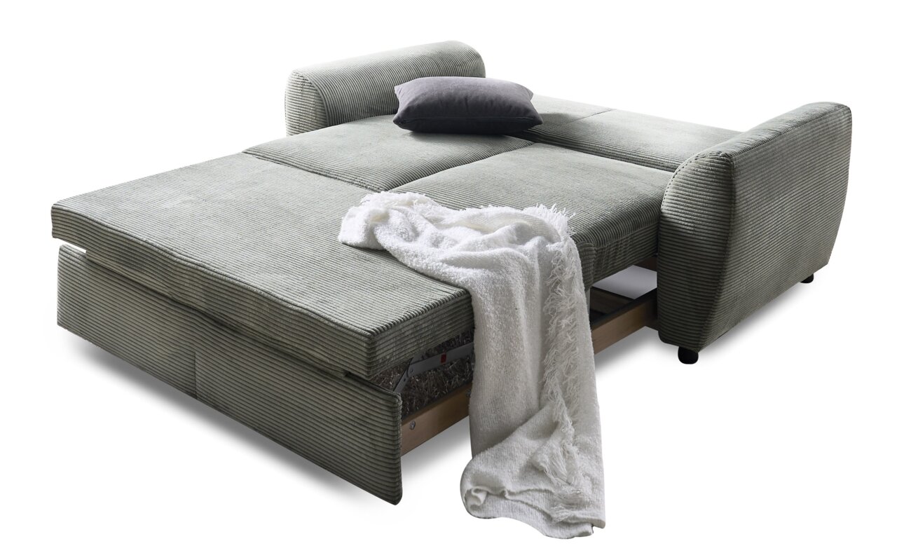 Funktionssofa in Liegeposition mit grauem Stoffbezug, Kissen und Decke, seitliche Perspektive