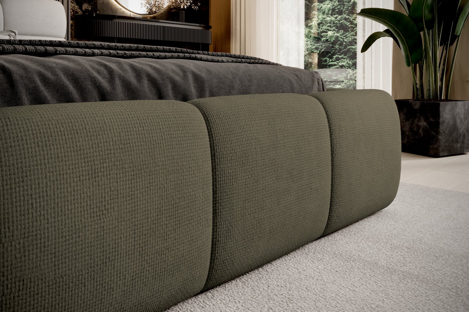 Close-up van een gestoffeerd bed met olijfgroene bekleding, gezien vanaf de zijkant