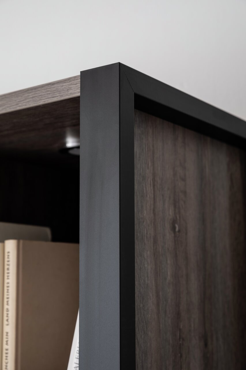 Nahaufnahme eines modernen Highboards mit dunklem Holz und schwarzem Metallrahmen, Perspektive von der Seite.