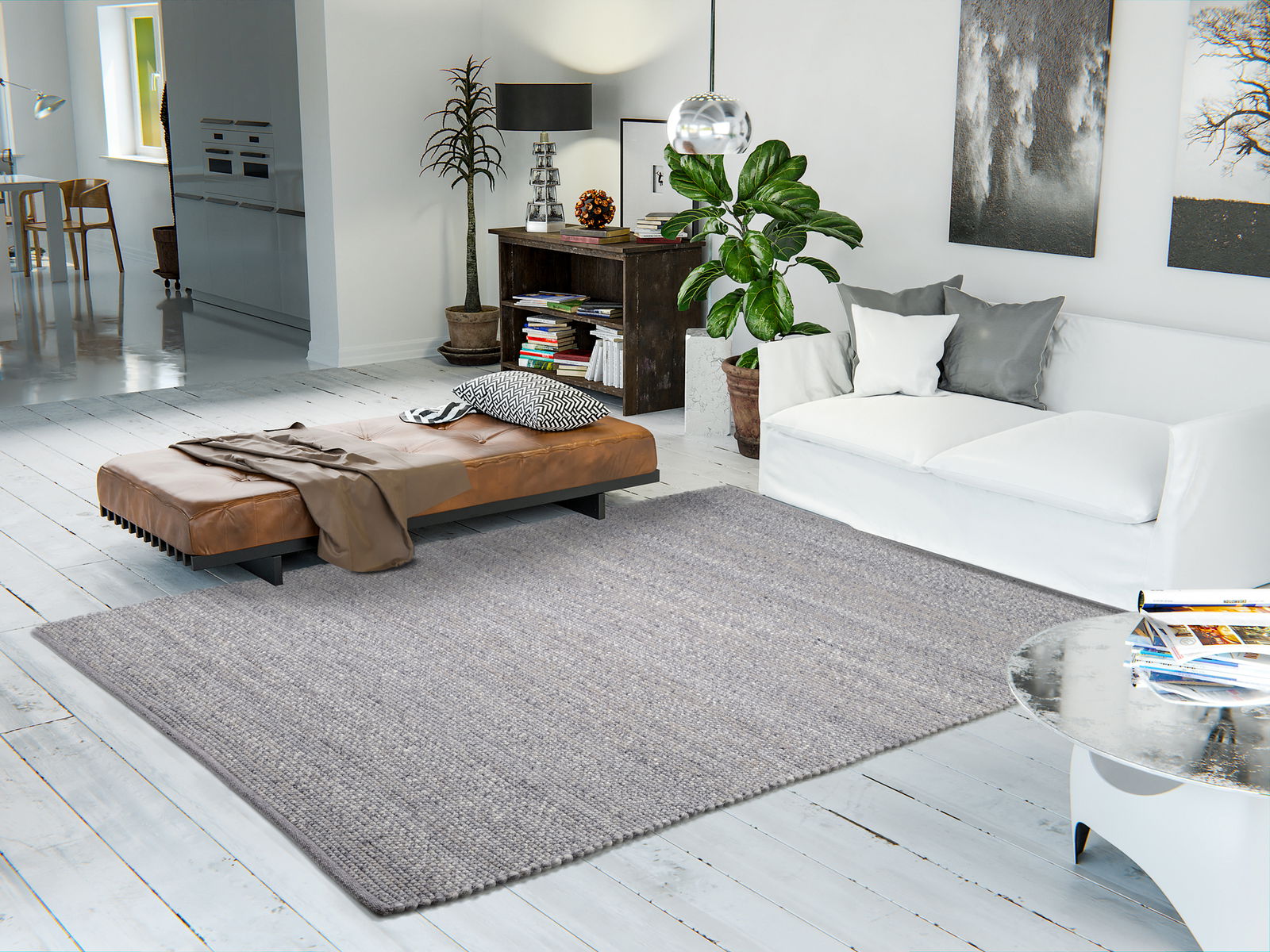 Moderner Wohnraum mit einem grauen Handweb Teppich, der auf einem hellen Holzboden liegt. Der Teppich ist zentral im Raum platziert, umgeben von einem weißen Sofa, einem braunen Ledersofa und einem runden Couchtisch. Die Perspektive zeigt den Teppich von 