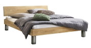 Modernes Doppelbett aus hellem Holz mit schlichtem Kopfteil und Metallfüßen, bezogen mit grauer Bettwäsche und Dekokissen, gezeigt in schräger Vorderansicht