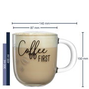 Transparente Tasse mit der Aufschrift 'Coffee FIRST', gefüllt mit Kaffee und Milchschaum, seitliche Perspektive.