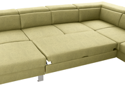 Grüne Ecksofa mit ausziehbarer Liegefläche, Perspektive von oben.