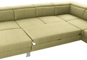 Grüne Ecksofa mit ausziehbarer Liegefläche, Perspektive von oben.