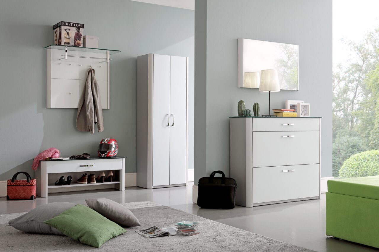 Moderne Garderobeneinrichtung mit Schuhschrank, Spiegel, Garderobenpaneel und Bank in einem hellen Raum, seitliche Perspektive.