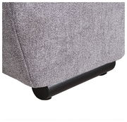 Nahaufnahme der unteren Ecke eines grauen Big Sofas TAVANI mit schwarzem Fuß, seitliche Perspektive.