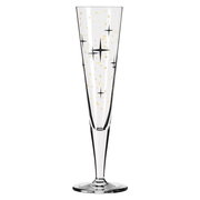 Champagnerglas mit goldenen und schwarzen Sternen, frontal betrachtet