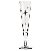 Champagnerglas mit goldenen und schwarzen Sternen, frontal betrachtet