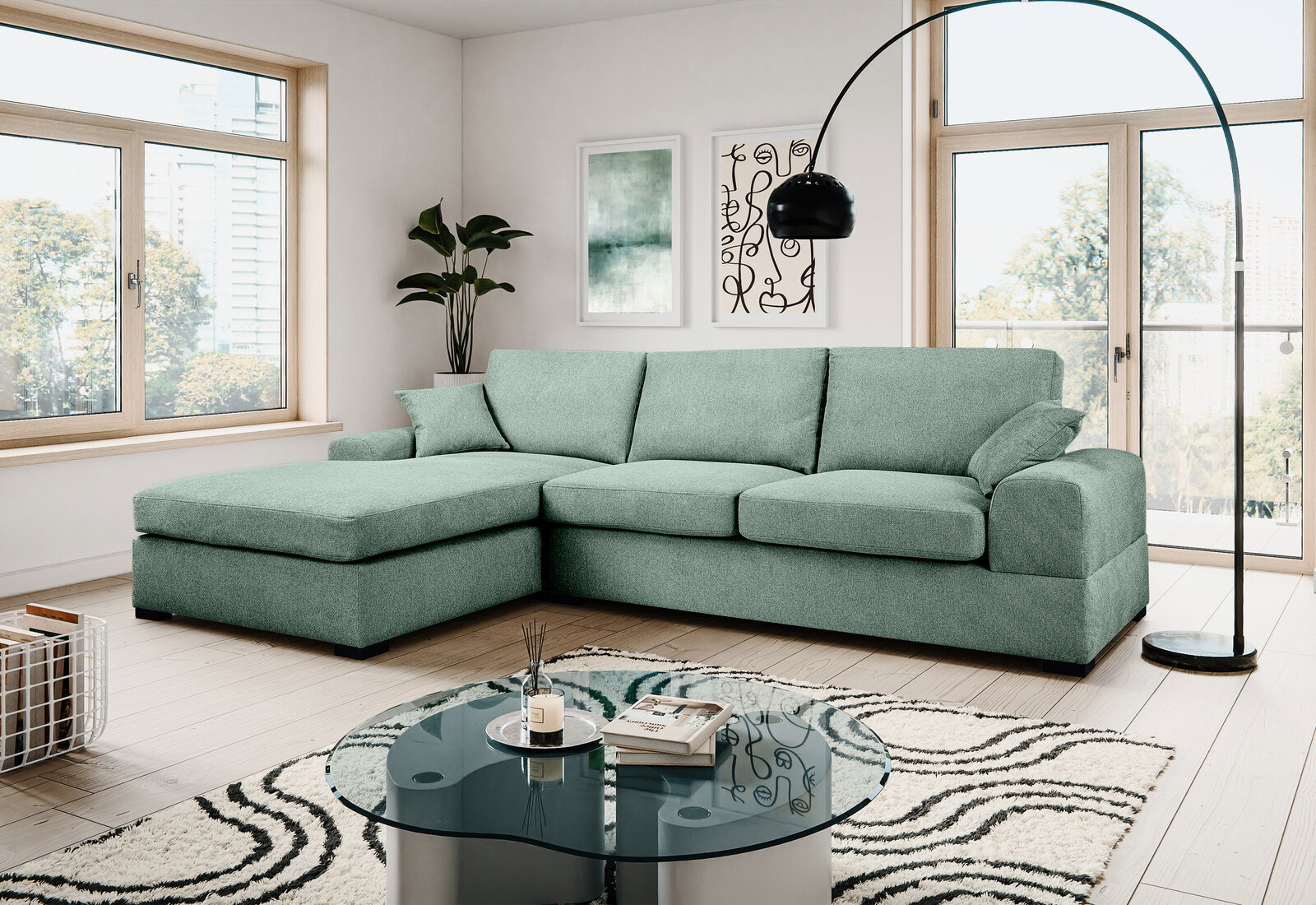 Mintgrünes L-förmiges Ecksofa mit Ottomane links und drei Sitzkissen in modernem Wohnzimmer, fotografiert in frontaler leicht schräger Perspektive.