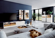 Modernes Wohnzimmer mit Highboard-Vitrine in heller Holzoptik, seitliche Perspektive