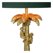 Goldene Tischlampe in Form einer Palme mit zwei Affen, die den Stamm hinaufklettern. Perspektive: Frontalansicht.