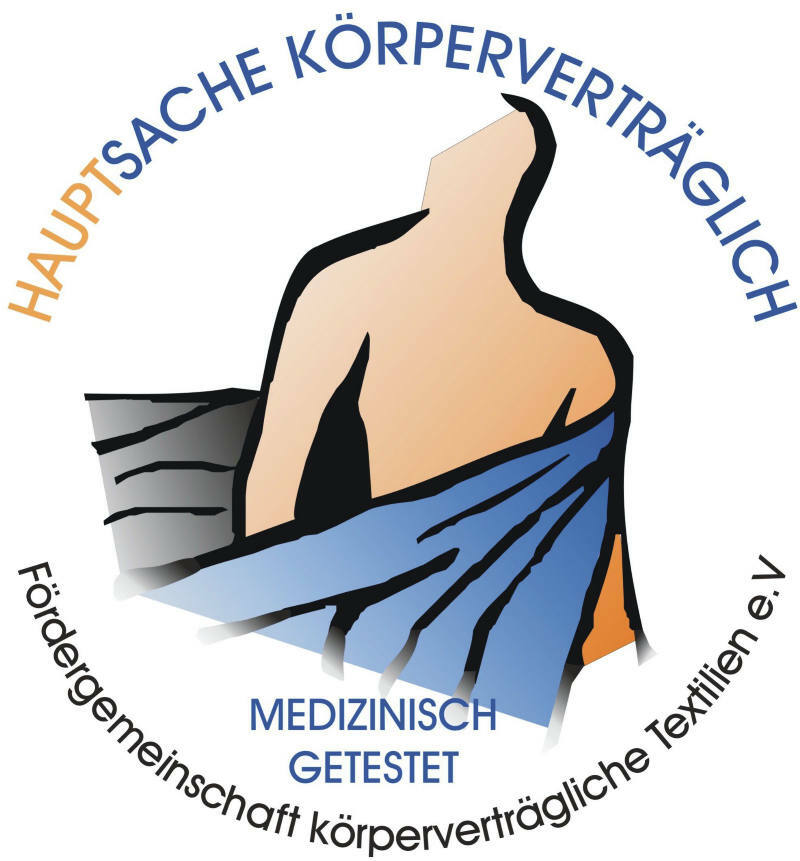 Logo der Fördergemeinschaft körperverträgliche Textilien e.V. mit der Aufschrift 'Hauptsache körperverträglich' und 'Medizinisch getestet', zeigt eine stilisierte Person mit einem Tuch um die Schultern, Vorderansicht.