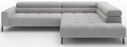 Lichtgrijze ribfluwelen hoekbank met chaise longue rechts, doorgestikte zitkussens, verstelbare hoofdsteunen en zwarte metalen poten, getoond in vooraanzicht licht schuin van voren