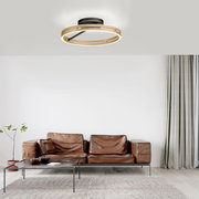 Moderne Deckenleuchte PURE Loop in einem stilvollen Wohnzimmer, von unten betrachtet.