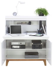 Moderne witte secretaire met open voorkant, voorzien van een laptop, bureaulamp, klok, plant en kantoorbenodigdheden.