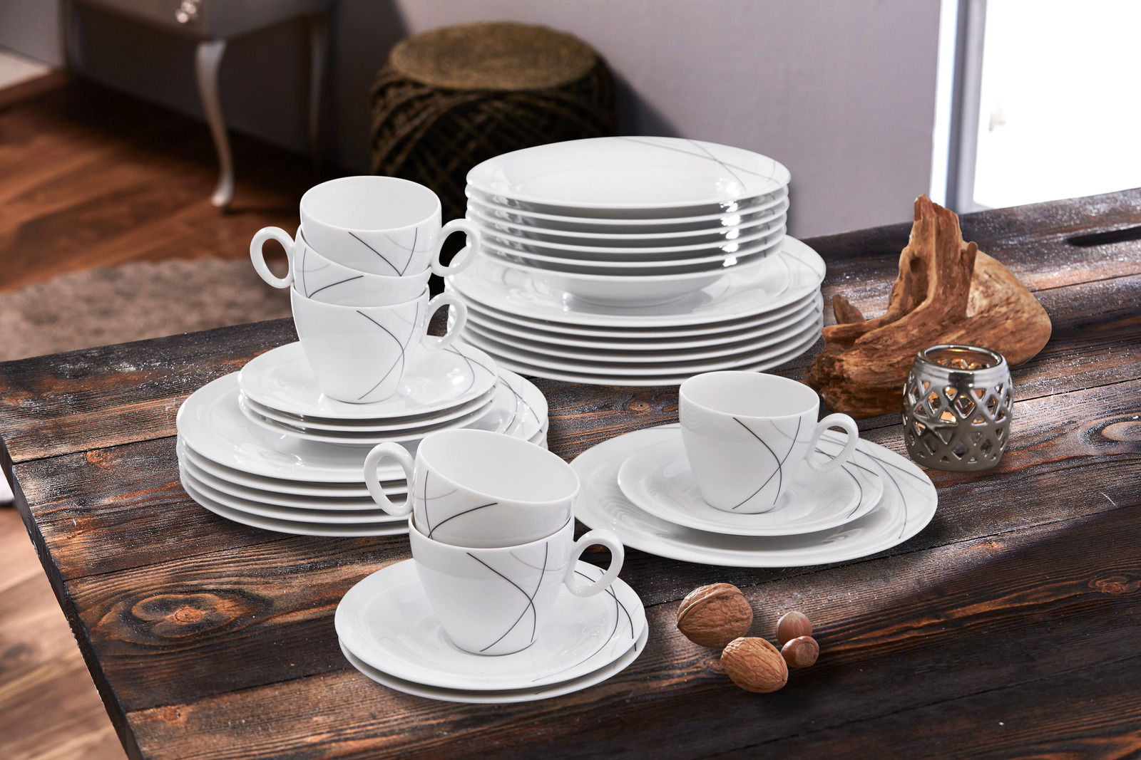 Kombiservice Trio Highl. 30-teilig, bestehend aus elegantem weißen Geschirr mit feinen grauen Linien, auf einem rustikalen Holztisch arrangiert. Perspektive von schräg oben.