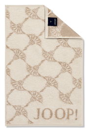 Beiges Gästetuch mit geometrischem Muster und dem Schriftzug 'JOOP!' in der unteren rechten Ecke, von oben betrachtet.