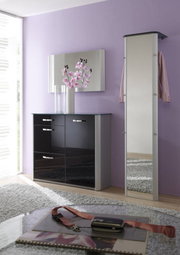 Moderner, schmaler Standspiegel in einem eleganten Raum mit lila Wand und schwarzem Schrank, seitliche Perspektive.