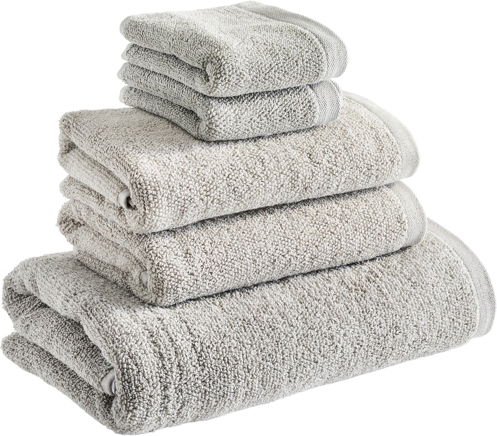 Ein Stapel von vier beigefarbenen Handtüchern in verschiedenen Größen, von oben fotografiert.