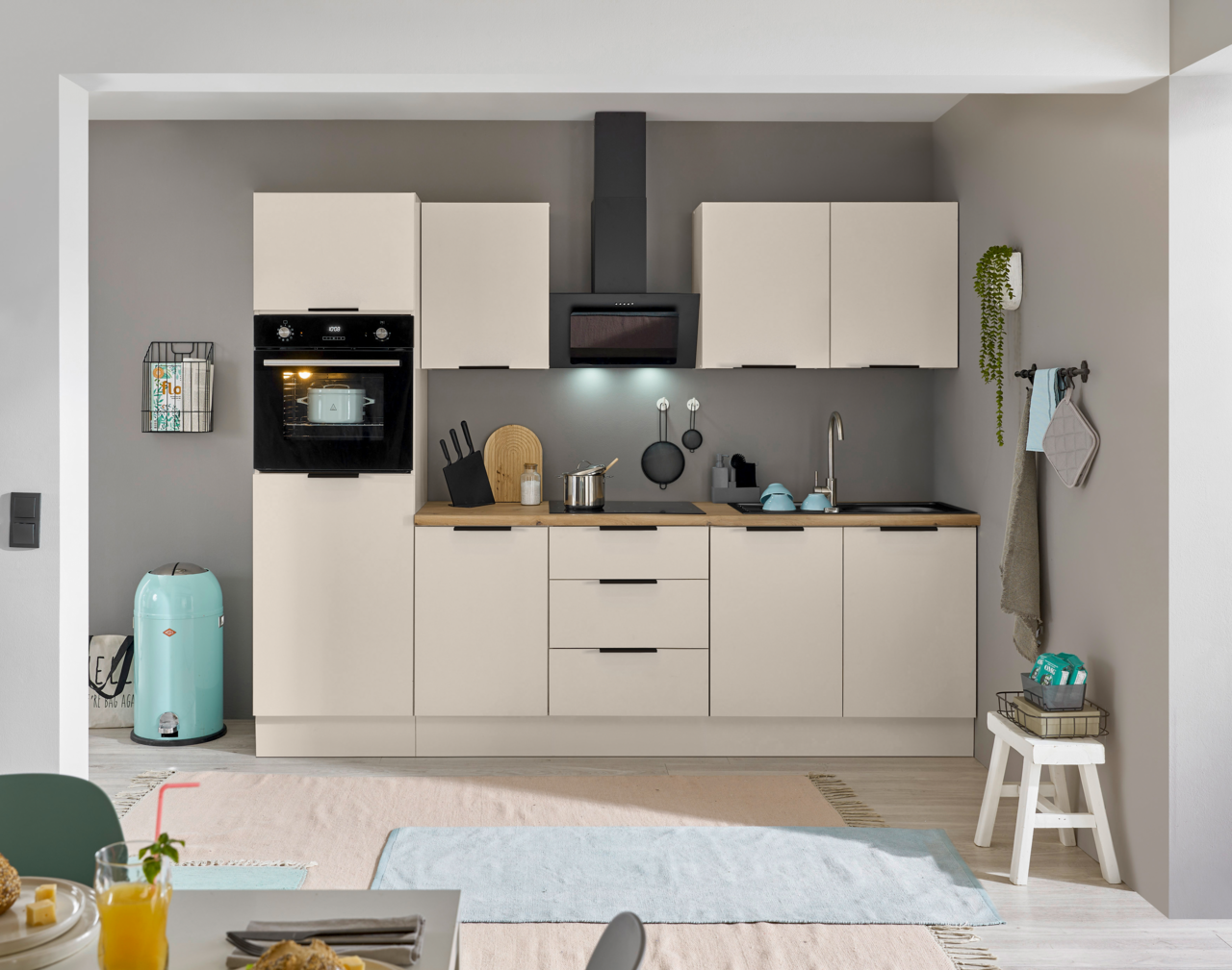 Moderne Küchenzeile mit eingebautem Backofen und Kühlschrank, frontal betrachtet.