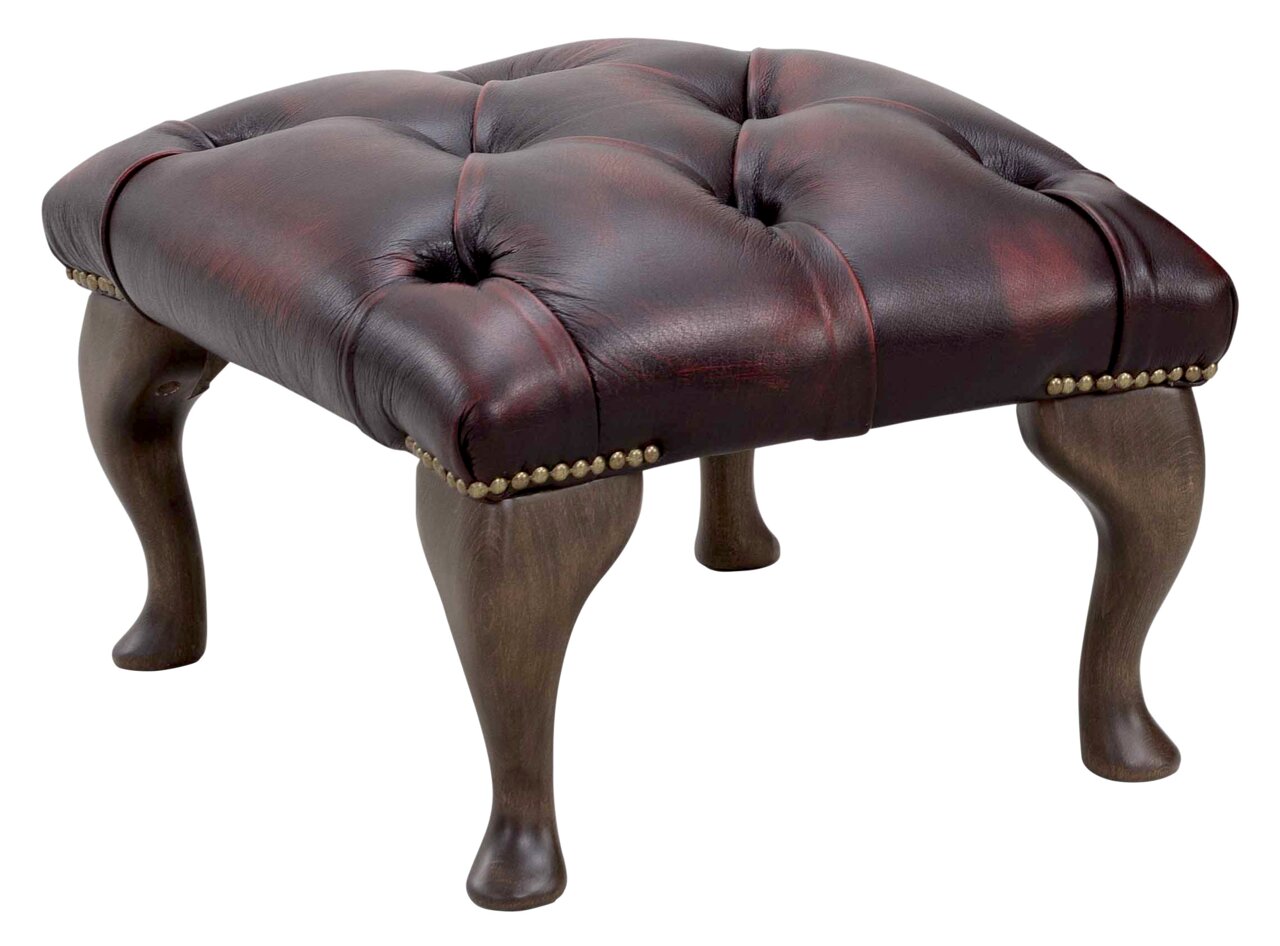 Eleganter Hocker mit gepolstertem, dunkelbraunem Lederbezug und dekorativen Nieten, seitliche Perspektive