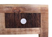 Nahaufnahme eines Couchtischs aus Holz mit rustikaler Schubladenfront und weißem Knopf, Frontalansicht.