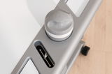 Nahaufnahme eines Schreibtischs mit grauem Drehknopf und USB-Anschluss, von oben fotografiert.