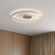 Moderne LED-Deckenleuchte mit zwei überlappenden, ringförmigen Lichtkreisen in Weiß an der Zimmerdecke, warmweiß leuchtend; Ansicht von unten in leichter Untersicht.