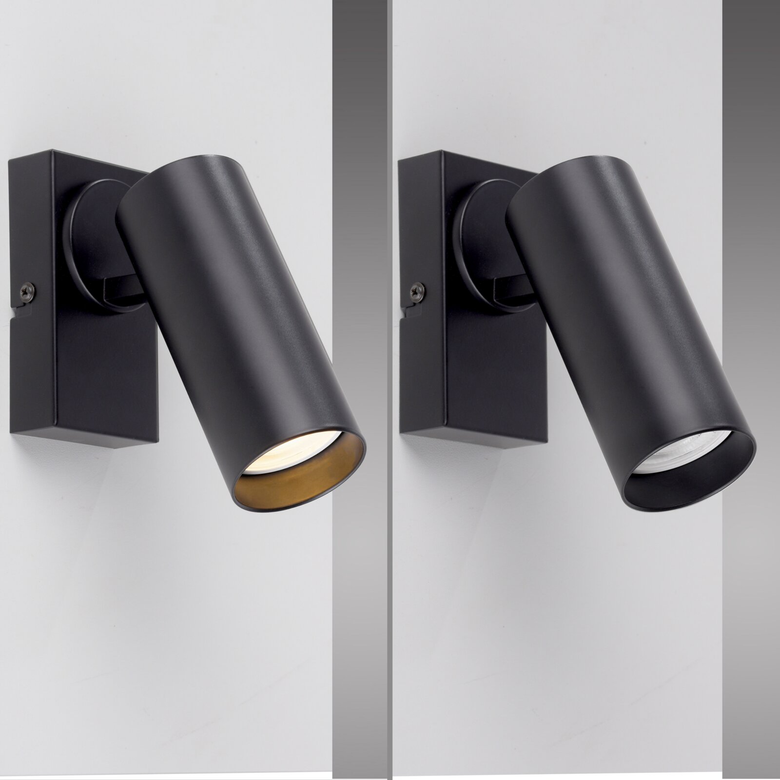 Schwarze, zylindrische Wand-Spotleuchte aus Metall mit schwenkbarem Kopf und quadratischer Wandhalterung, schräg von vorn in Nahaufnahme fotografiert.