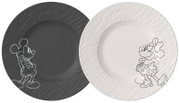 Zwei runde Teller/Platten im Set, links schwarz mit geprägter Struktur und skizzierter Minnie-Maus-Figur, rechts weiß mit geprägter Struktur und skizzierter Minnie-Maus-Figur, Draufsicht von oben