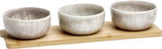 Drei Schalen aus Keramik mit natürlichem Muster auf einem Holztablett, seitliche Perspektive