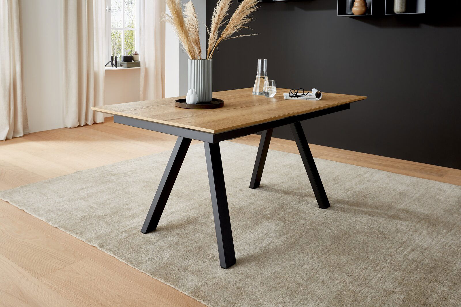 Moderner Esstisch mit Holzplatte und schwarzen Metallbeinen, seitliche Perspektive