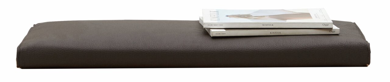 Braunes Sitzkissen der Serie SORRENT von Dieter Knoll, seitliche Perspektive, mit zwei darauf liegenden Zeitschriften.