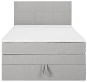 Graues Boxspringbett in Frontalansicht mit gepolstertem Kopfteil und weißer Matratzenauflage.