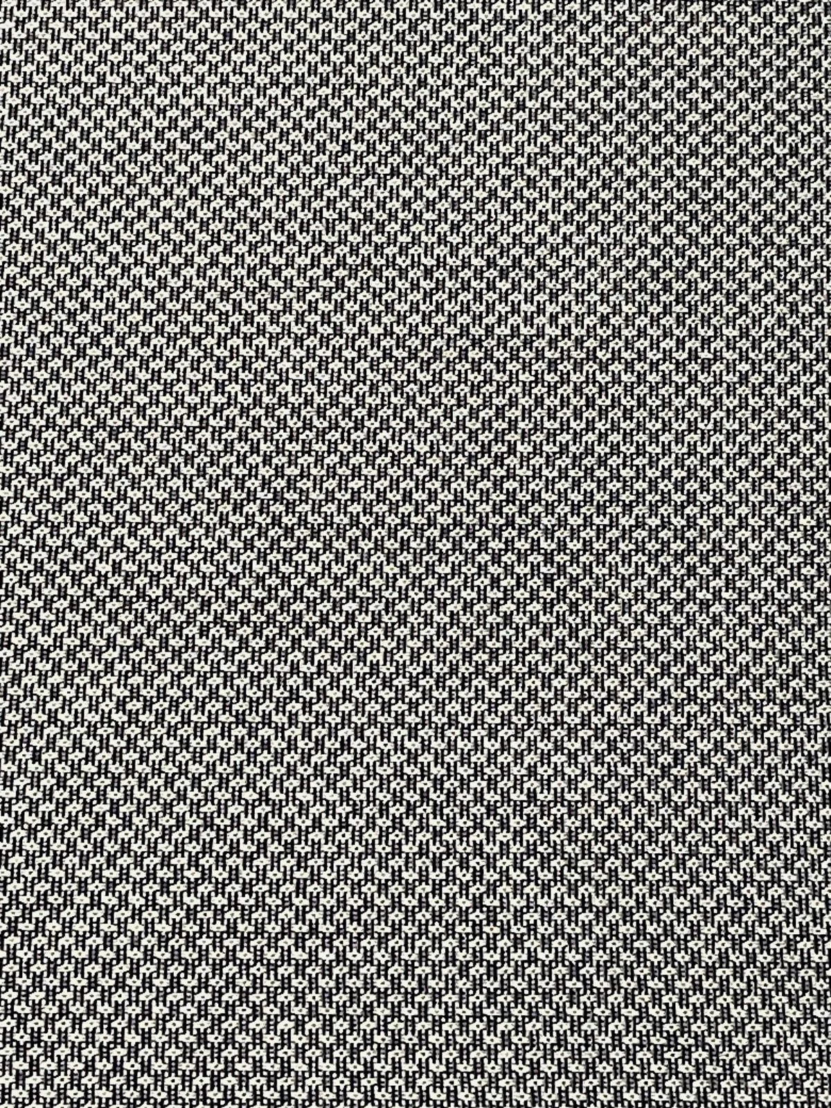 Nahaufnahme eines schwarz-weiß gemusterten Stoffes, der für eine Hochlehnerauflage verwendet wird.
