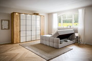 Boxbett mit Stauraum in einem hellen Schlafzimmer, seitliche Perspektive